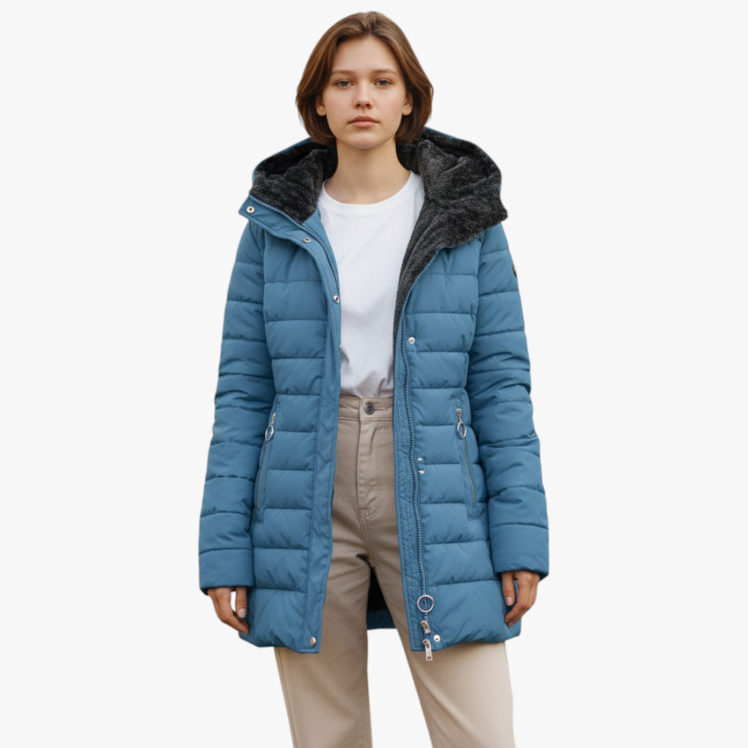 Person wearing a blue puffer jacket with black fur lining on a white background