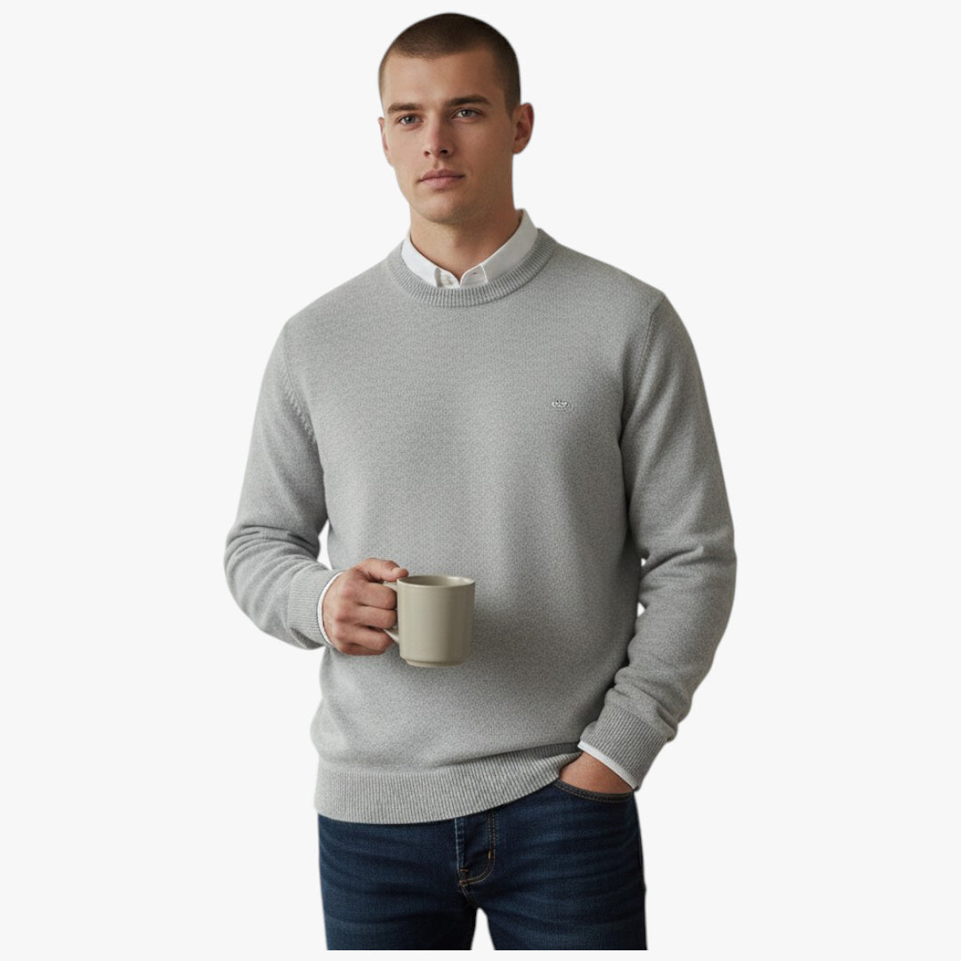 Man wearing a gray sweater holding a mug on a white background