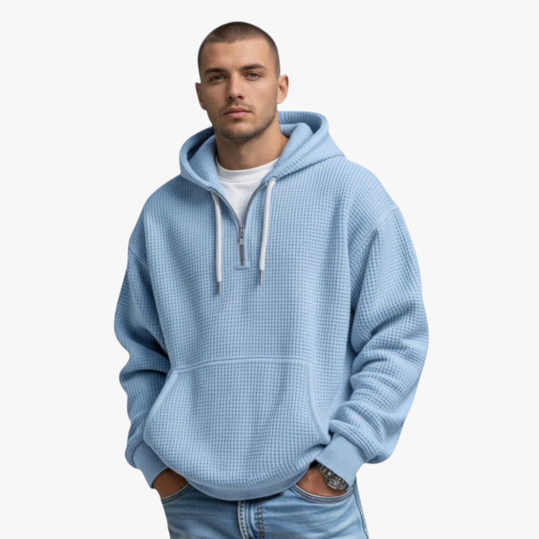 Man wearing a light blue hoodie on a white background