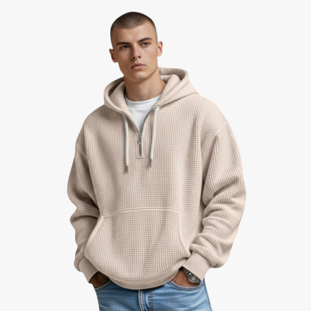 Man wearing a beige hoodie on a white background
