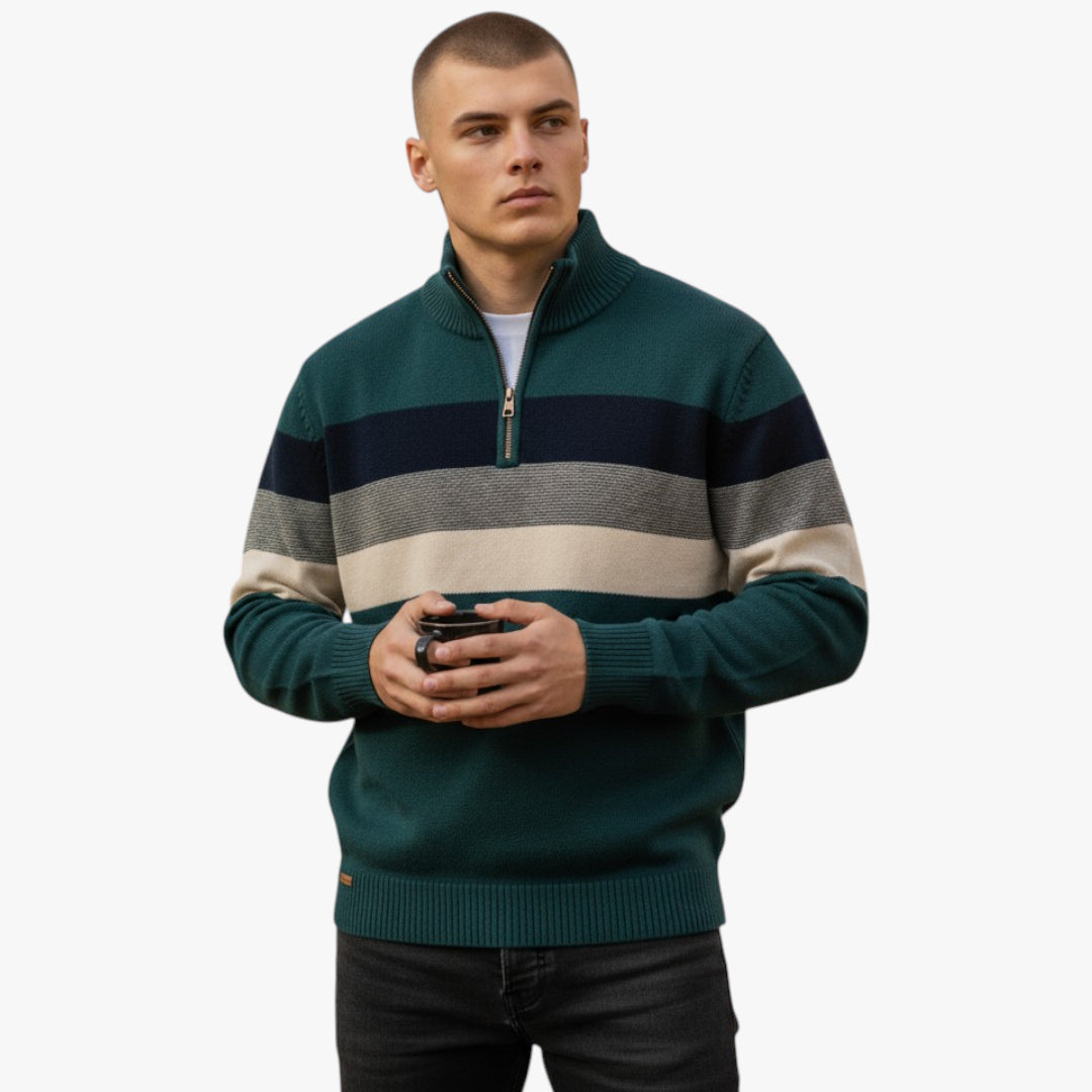 Man wearing a green striped sweater holding a phone on a white background