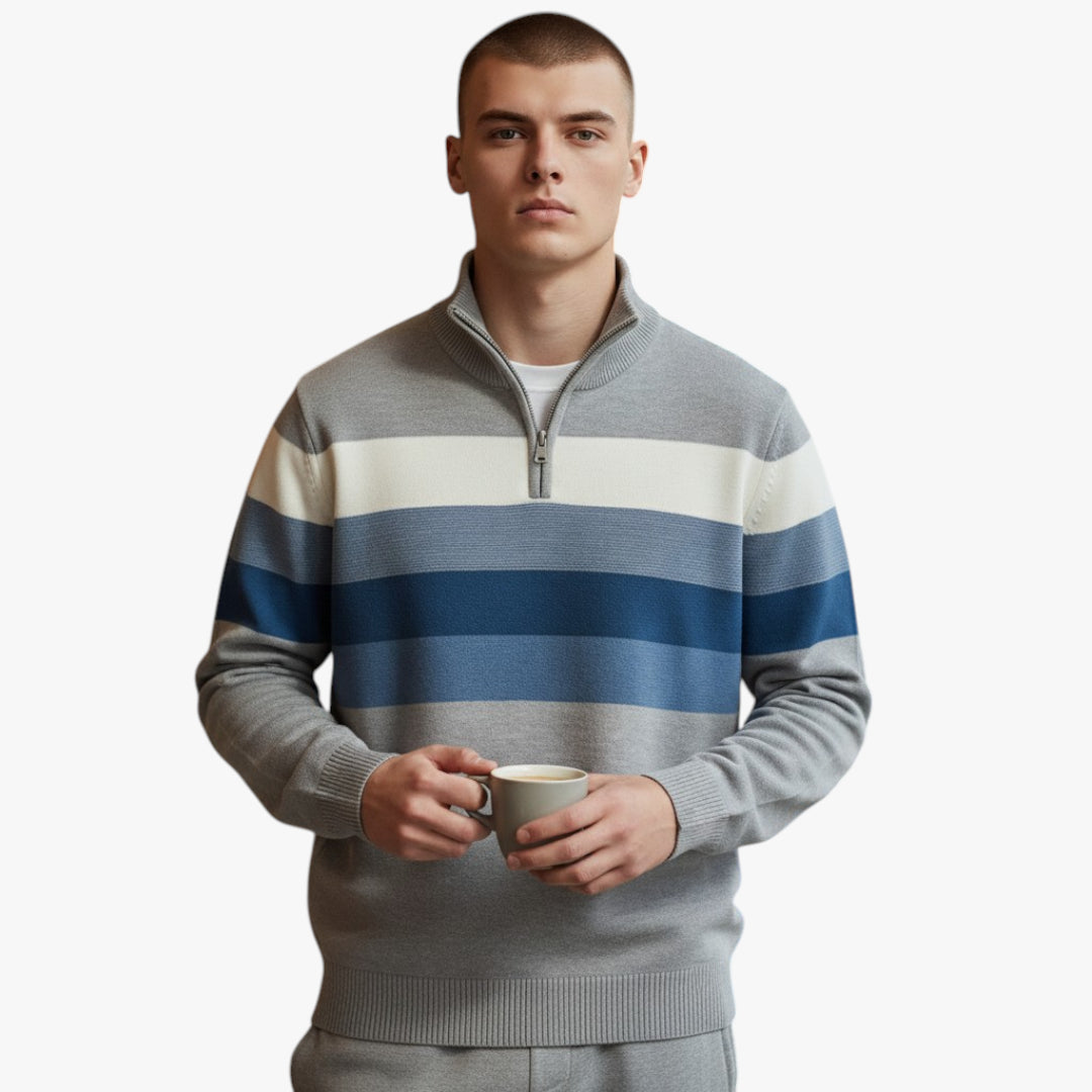 Man wearing a striped sweater holding a cup on a white background