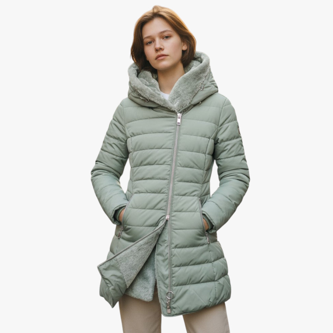 Woman wearing a light green puffer coat with a fur-lined hood on a white background