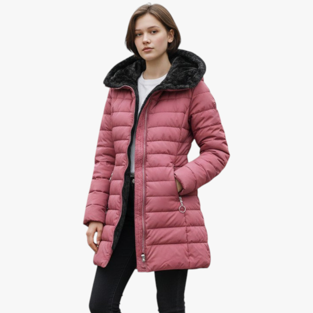 Pink puffer coat with black fur hood worn by a person on a white background
