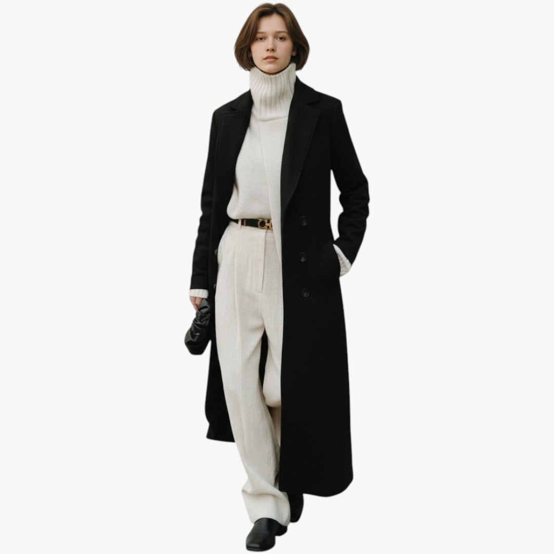 Person wearing a long black coat over a white outfit on a white background