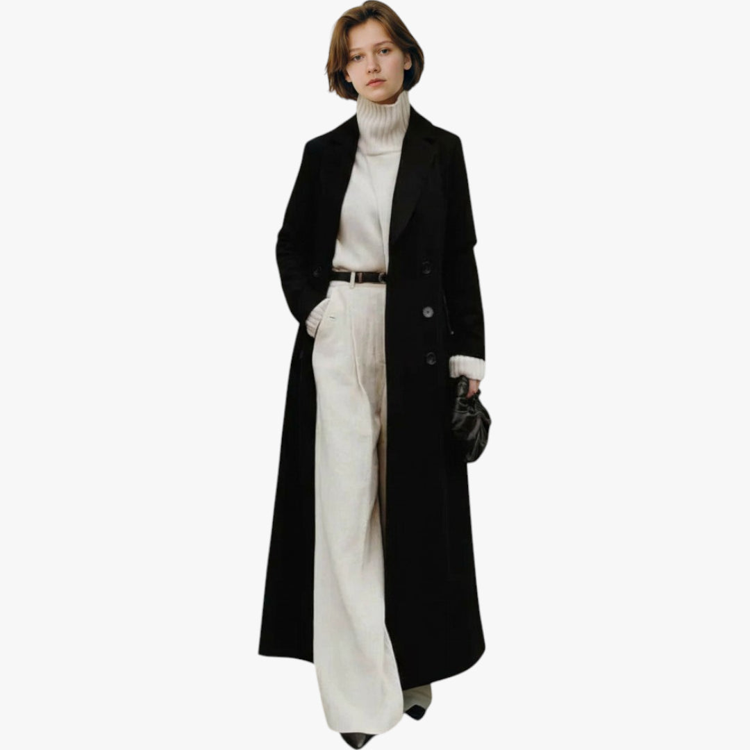 Woman wearing a long black coat over a white outfit on a white background