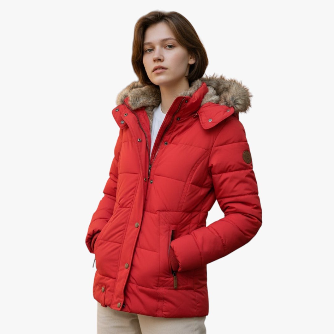 Woman wearing a red puffer jacket with fur hood on a white background